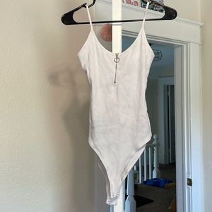 white zip up body suit